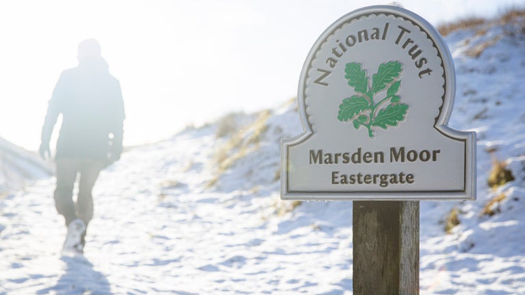 A man walking in the snow with an omega sign that says Eastergate